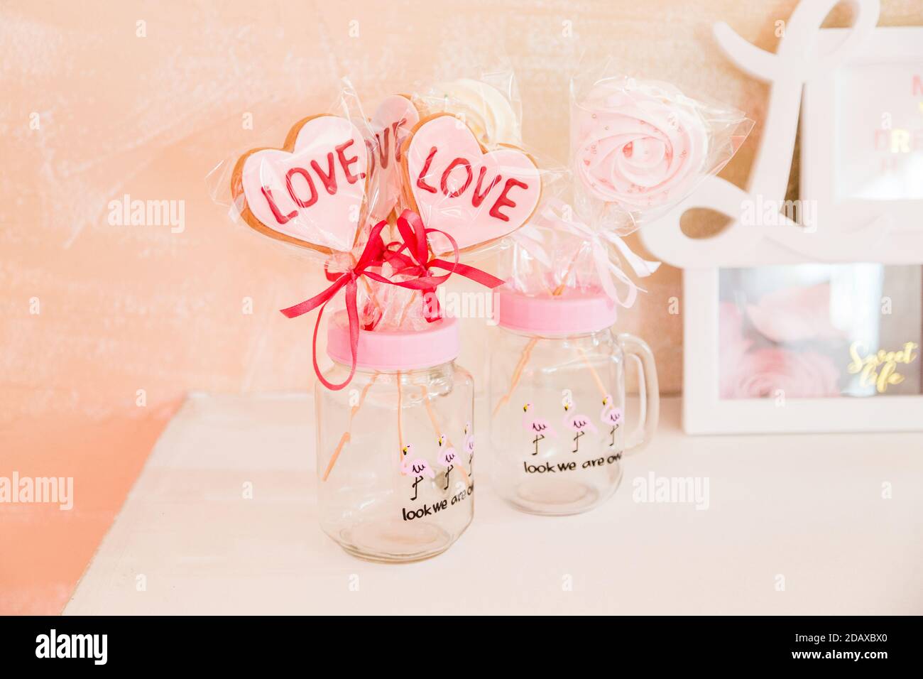 Süßigkeiten auf einem Stick in einem transparenten Glas valentine's Tagesdekoration Stockfoto
