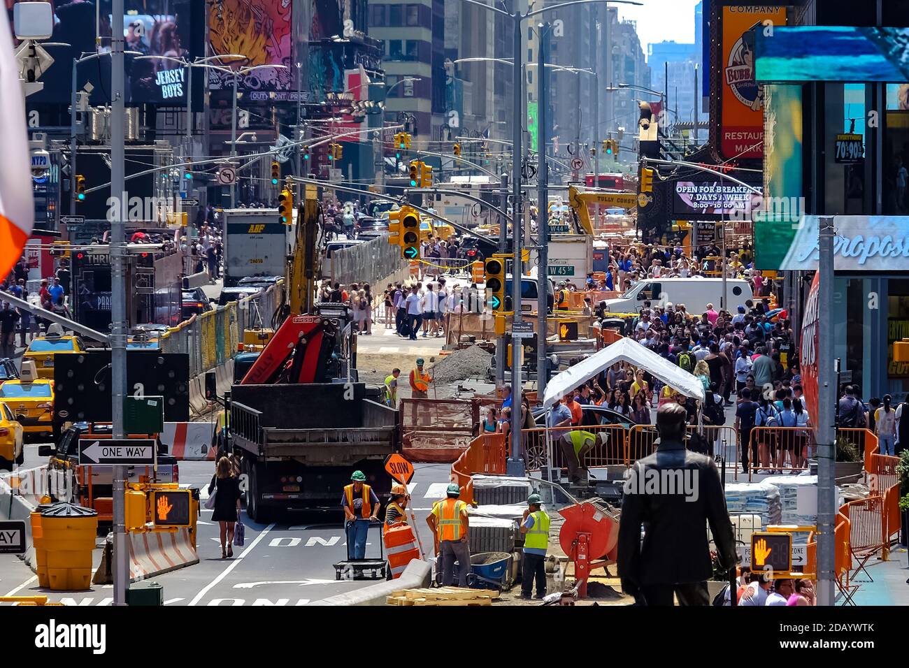 Times Square with yellow New York City Taxi cabs and tour buses driving through colorful billboards. Stockfoto