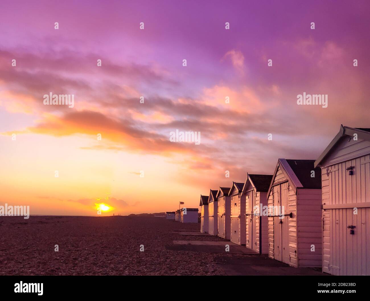 Der Sonnenuntergang über einem Sussex Strand mit einem violetten Himmel. Stockfoto