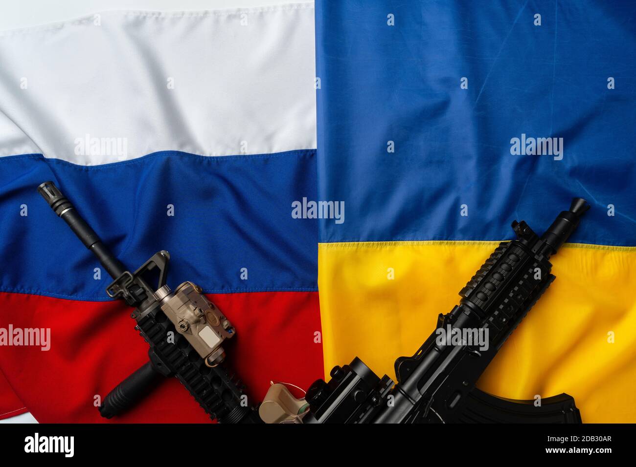 Flaggen von Russland und der Ukraine gefaltet zusammen mit Gewehr Stockfoto