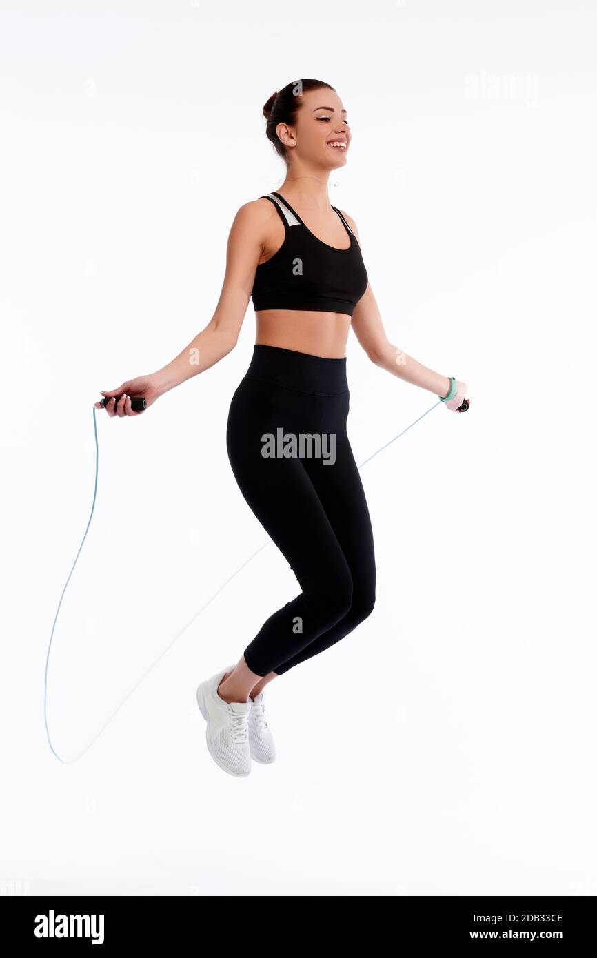Spotrswoman springen mit Seil auf weißem Hintergrund isolieren. Fitness weibliche tun körperliche Bewegung. Healthcare und Gewichtlose Konzept Stockfoto