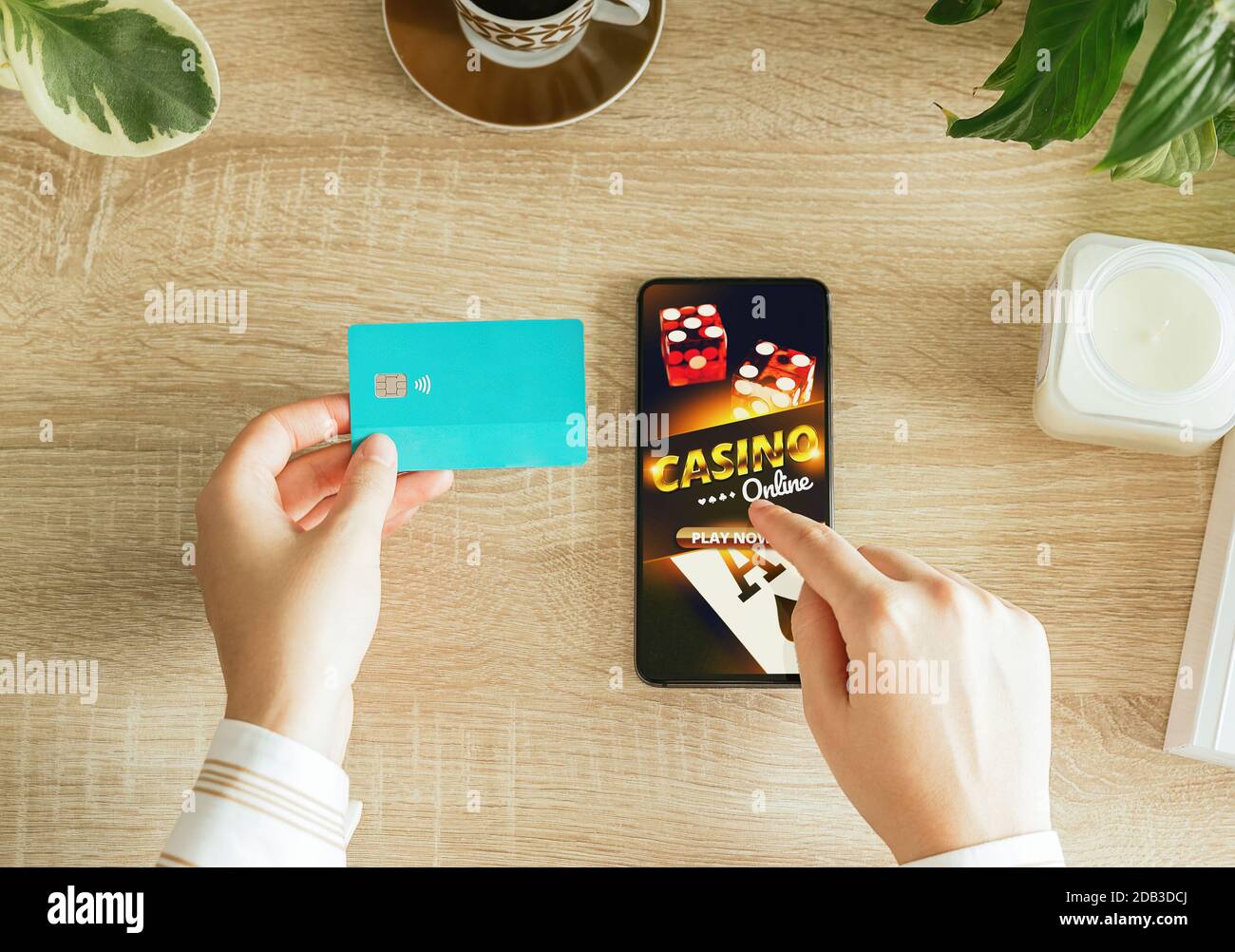 Stock Foto von einer Frau gehen, um Online-Casino aus ihrem Wohnzimmer spielen und halten eine Kreditkarte zu bezahlen. Overhead-Ansicht Stockfoto
