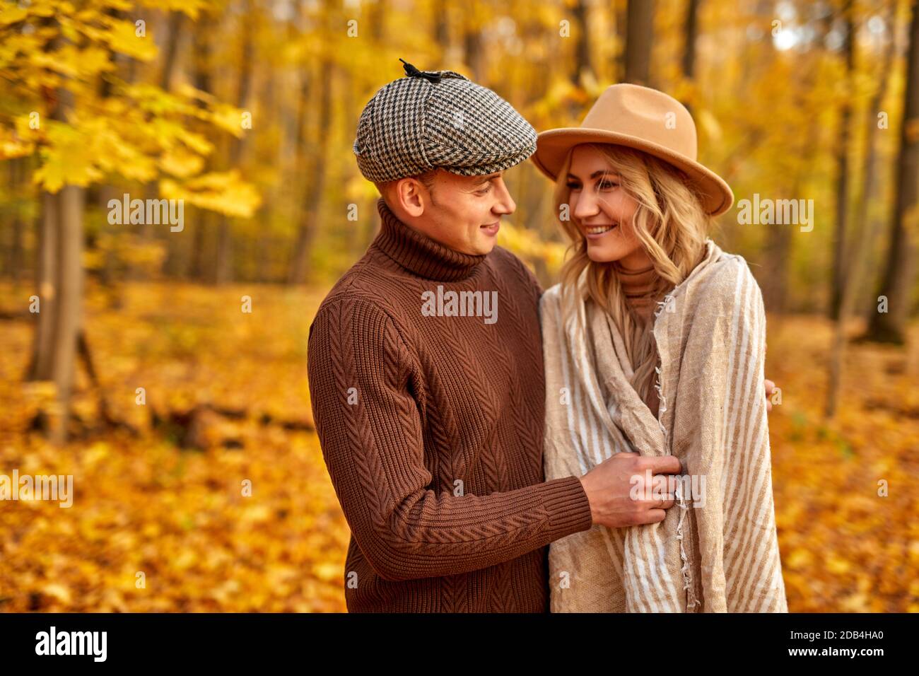 Schöner Mann ist freundlich zu seiner Frau, Liebesgeschichte im Herbst Wald oder Park, verbringen Freizeit zusammen in der Natur, posieren Stockfoto