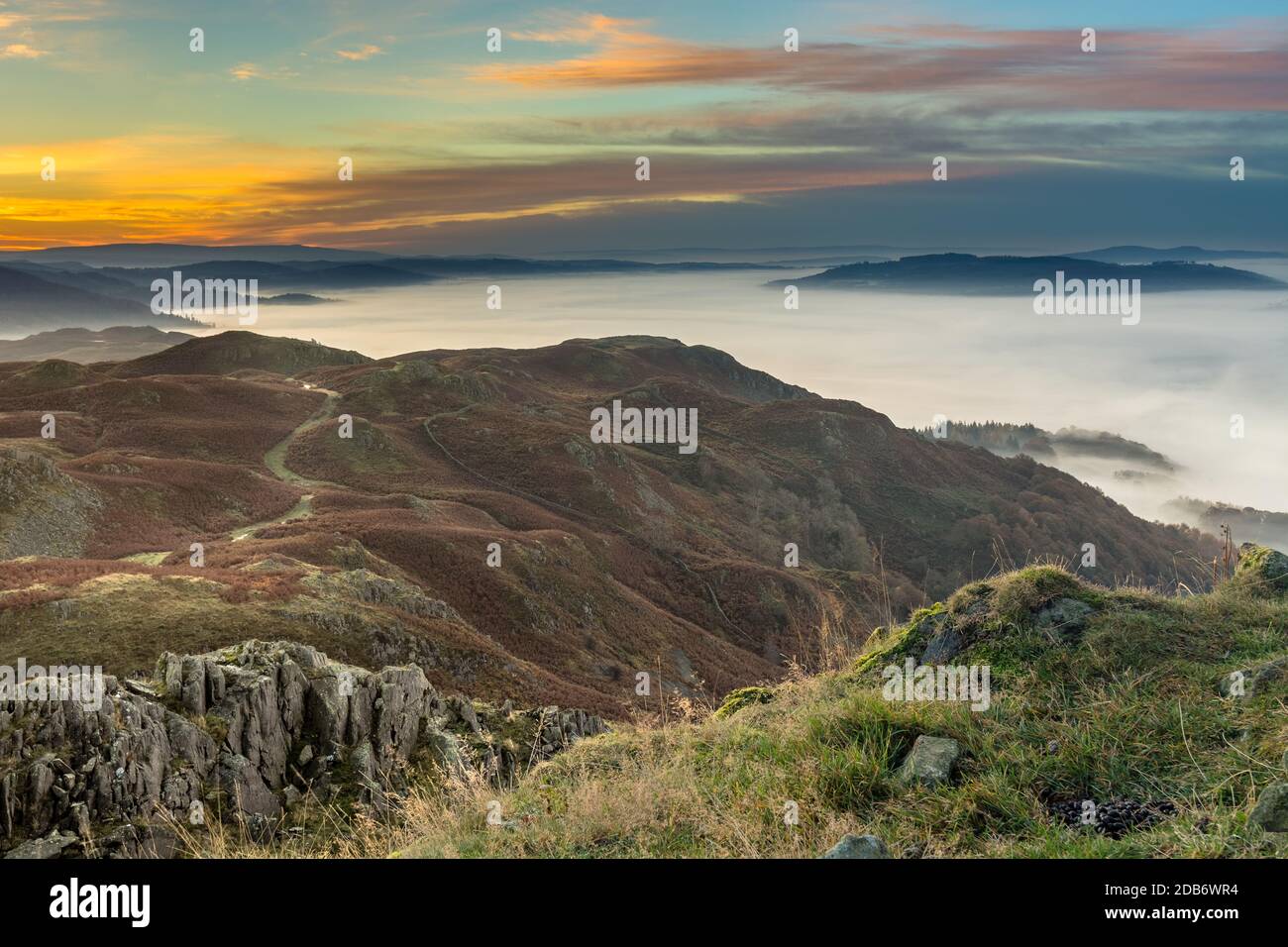 Schöner Herbstaufgang von Loughrigg fiel im Lake District mit herrlich anhaltendem Nebel über dem Cumbrian Valley. Stockfoto