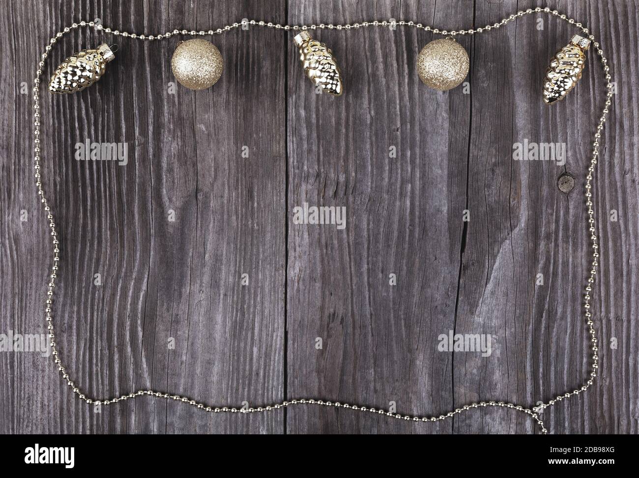 Goldene Kugeln auf Holzhintergrund. Weihnachtsdekoration. Stockfoto