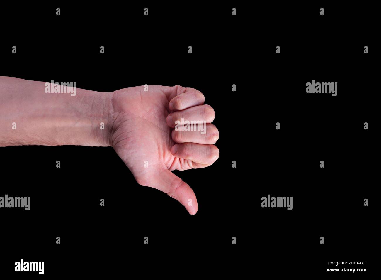 Die Hand des europäischen Mannes zeigt ein Schild mit den Daumen nach unten auf einem isolierten schwarzen Hintergrund Stockfoto