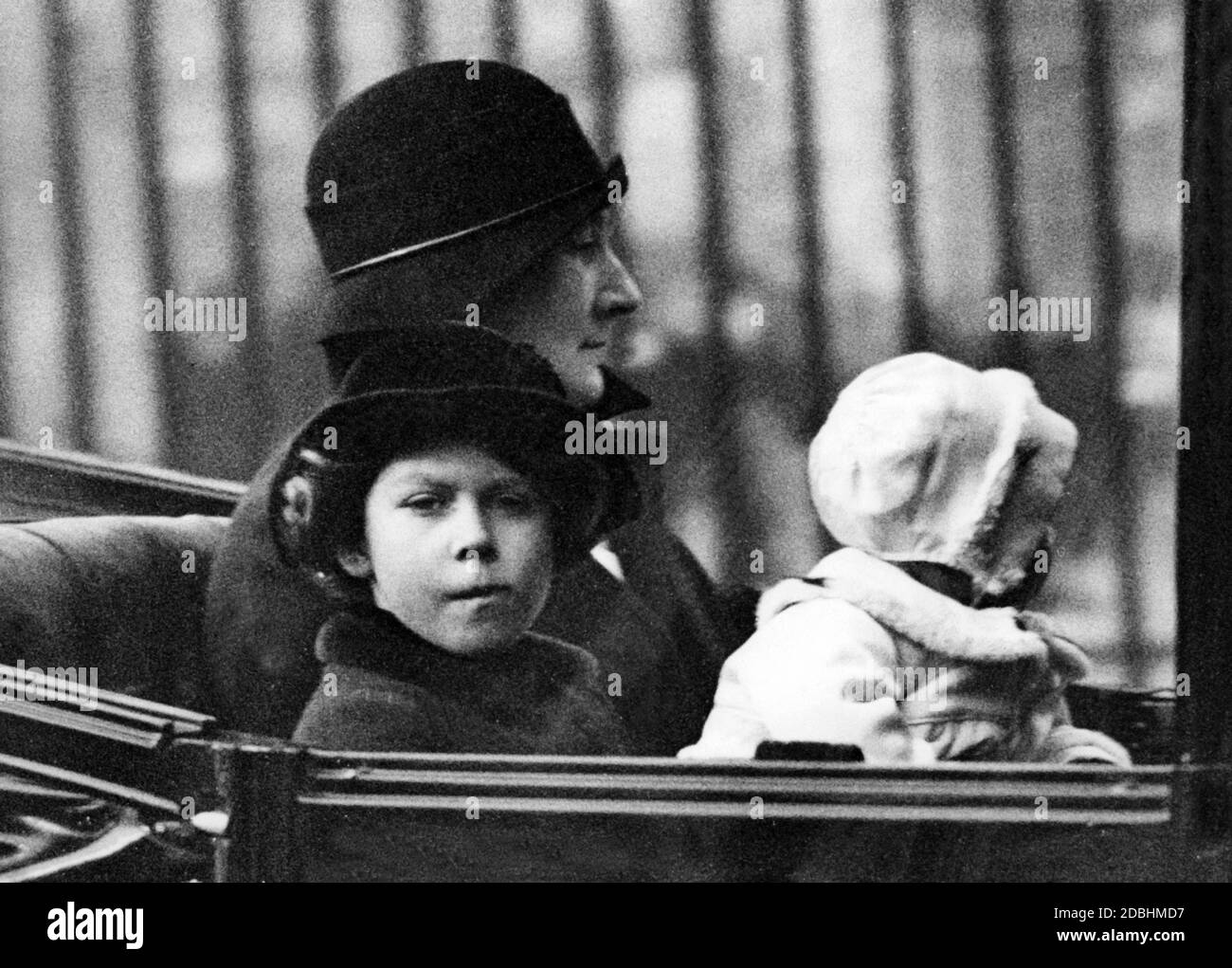 Elizabeth II. Reist mit ihrer Schwester Margaret Rose und ihrer Kindermädchen in einem offenen Auto durch Cariff. Stockfoto