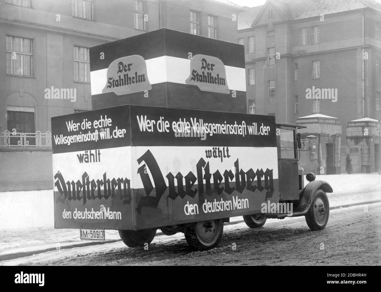 "Ein Fahrzeug des Stahlhelm mit Wahlplakaten fährt durch die Straßen und ruft die Menschen auf, Theodor Düsterberg als Reichspräsidenten zu wählen. Sie werben mit dem Slogan ''Wer will die wirkliche Volksgemeinschaft, wählt Düsterberg zum Deutschen.''' Stockfoto