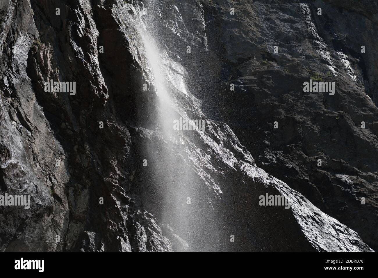 Wasser tropfend auf schwarzem Felsen Stockfoto