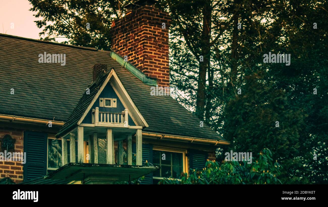 Ein Vogelhaus, das aussieht wie ein echtes Haus auf Ein Vorburban-Grundstück Stockfoto