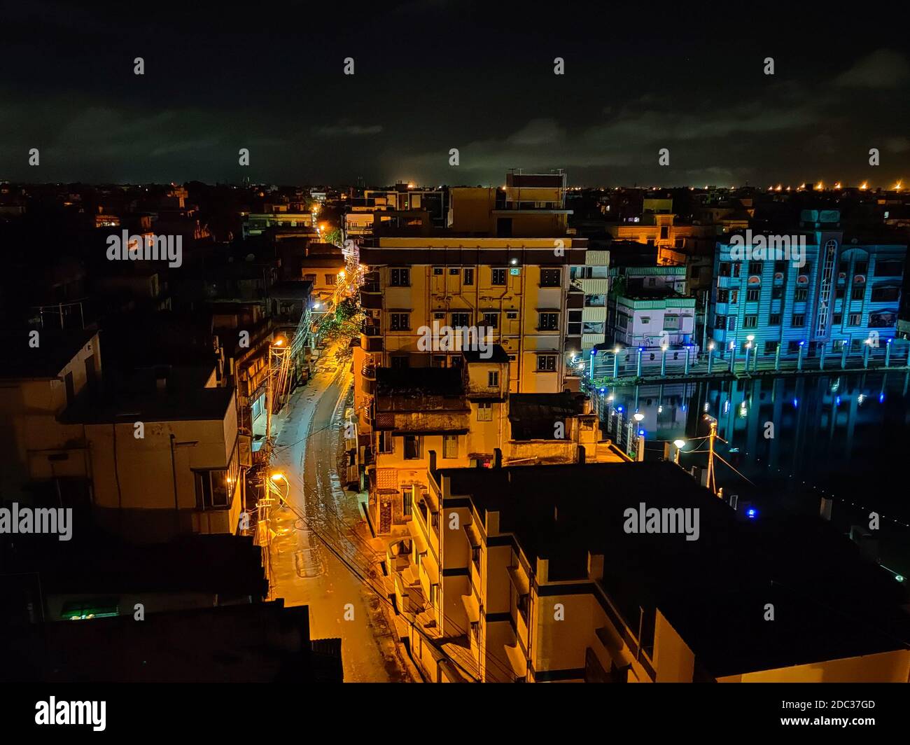Bild von Nachtansicht einer Stadt mit einer geschwungenen Straße zusammen mit Straßenlaternen. Stockfoto