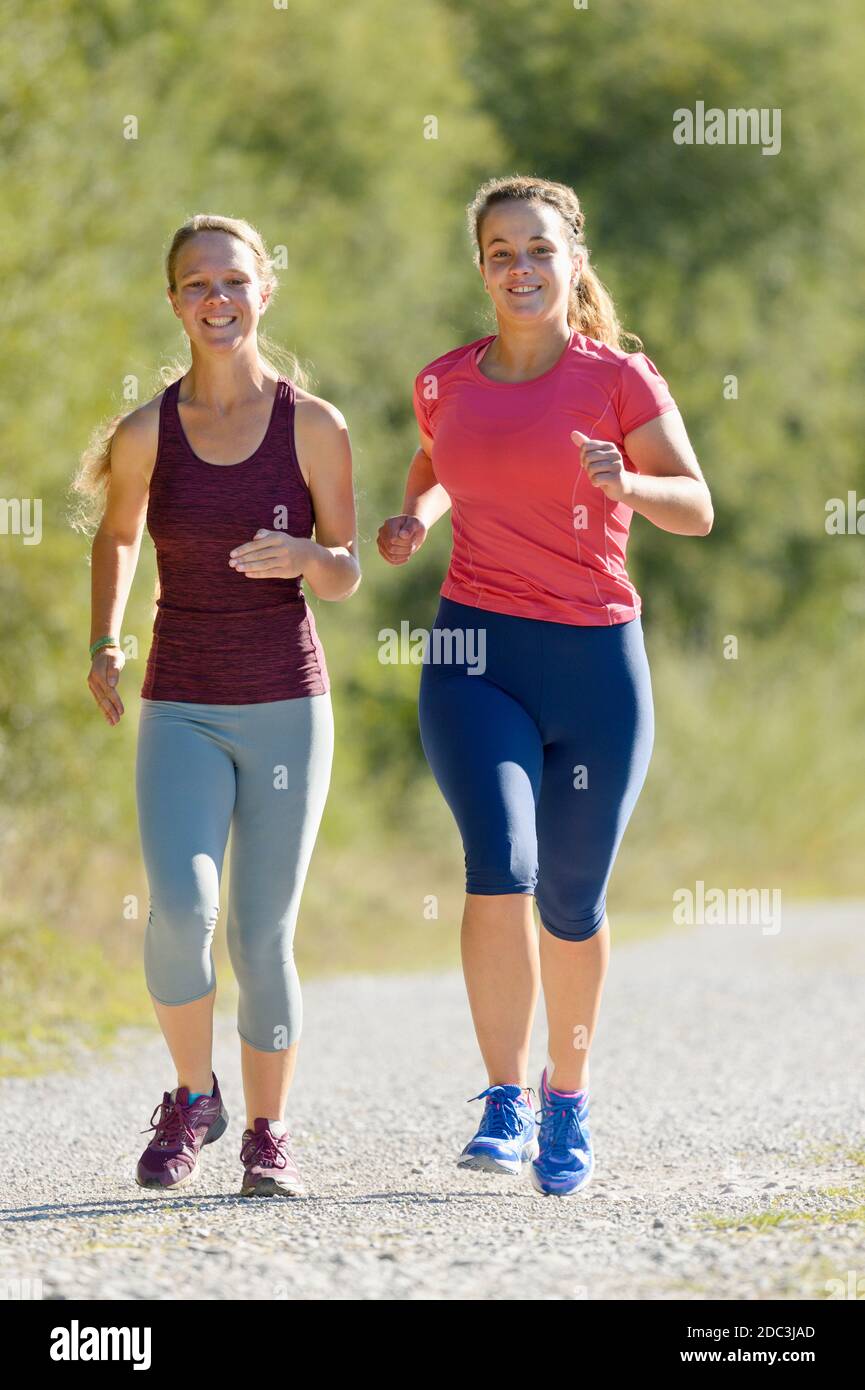 Zwei junge Frauen joggen im Spätsommer Stockfoto