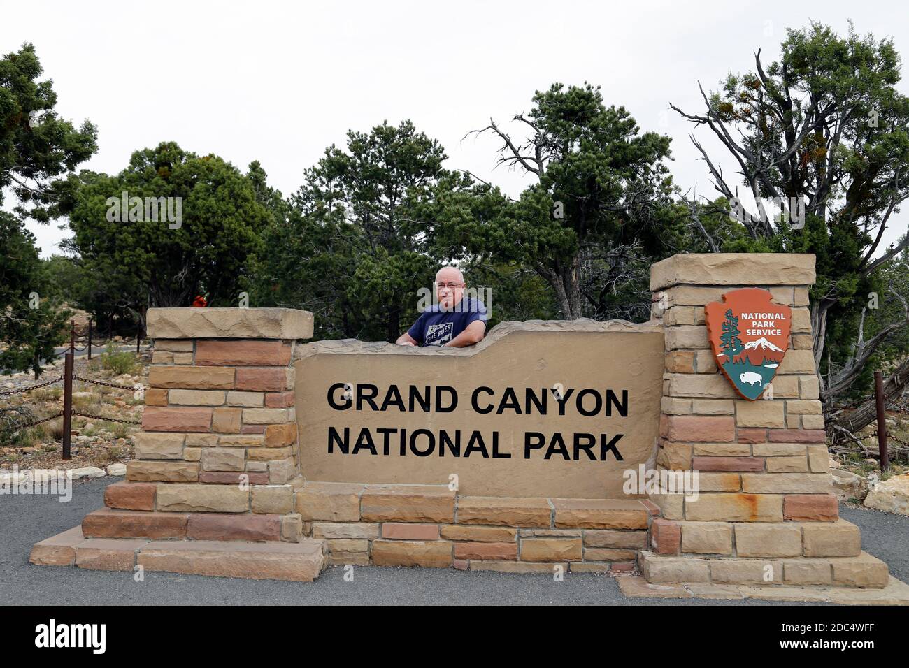 Am 27. Oktober 2016 steht ein Tourist am Schild des Grand Canyon National Park vom Südrand aus. Stockfoto