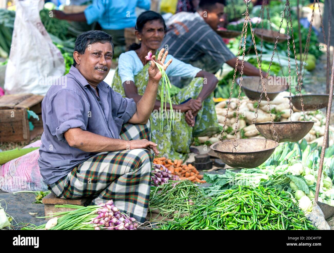 Ein Obst- und Gemüseverkäufer auf einem Straßenmarkt in der Nähe von Mirissa an der Südküste Sri Lankas. Stockfoto