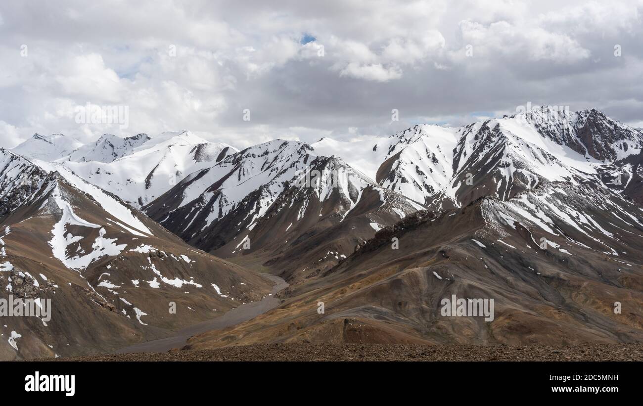 Bergpanorama am AK-Baital Pass mit Blick auf verschneite Hochgebirge und Tal. Stockfoto