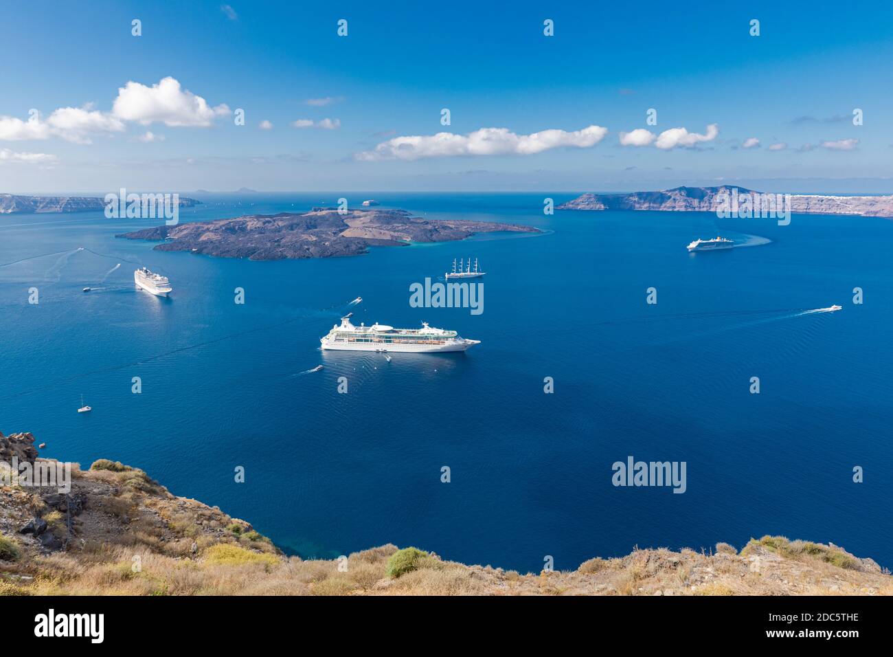 Kreuzfahrtschiffe in der Nähe von Santorini, wunderschöne Meeresbucht mit Vulkanfelsen. Reiseziel für den Sommer Stockfoto