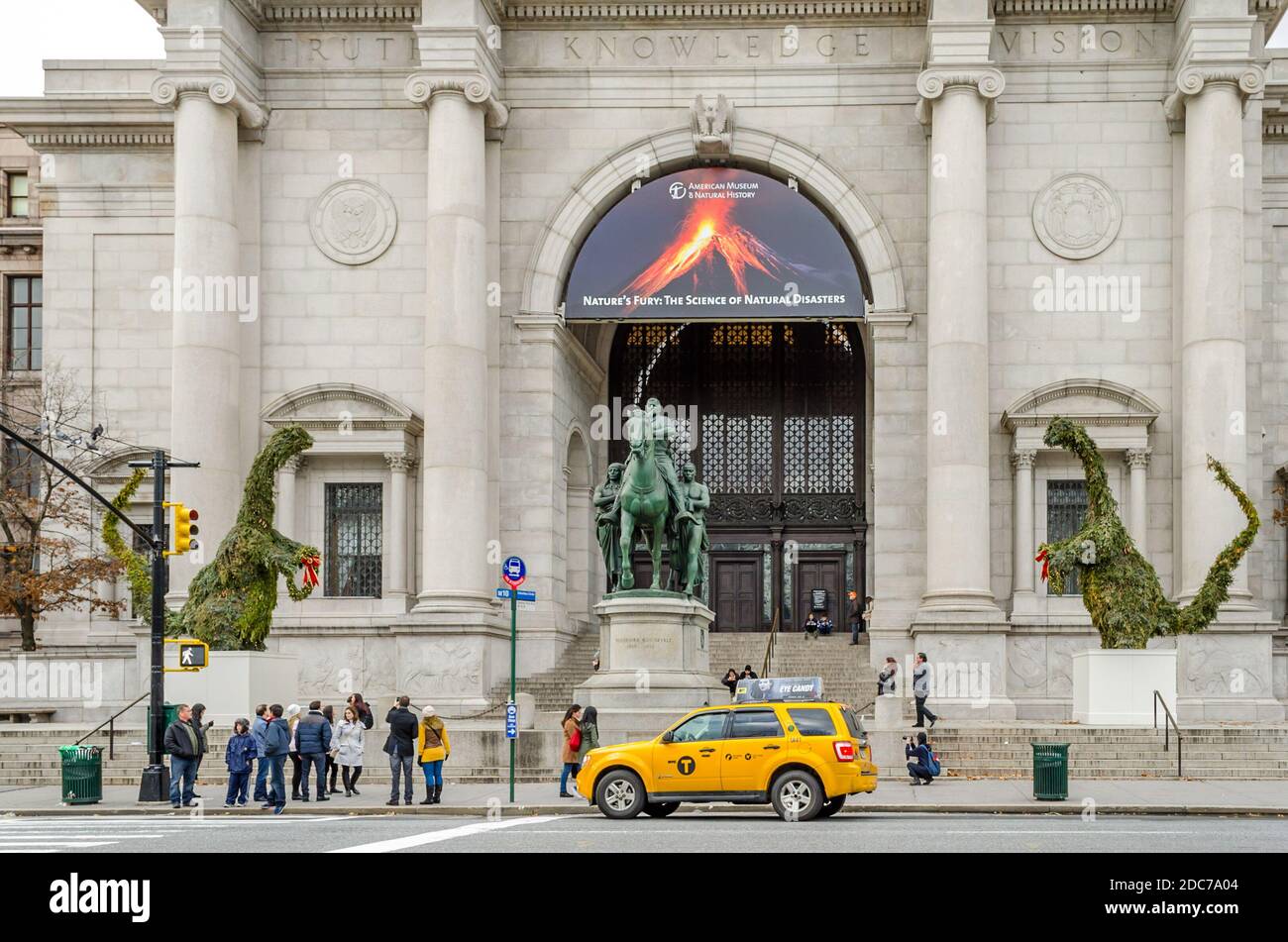 Fassade und Eingang des American Museum of Natural History in Manhattan. Vor dem Gebäude wartet ein gelbes SUV-Taxi auf einen Passagier. Stockfoto