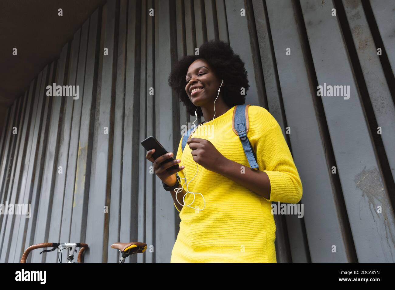 afroamerikanische Frau mit Smartphone auf einer Straße Stockfoto