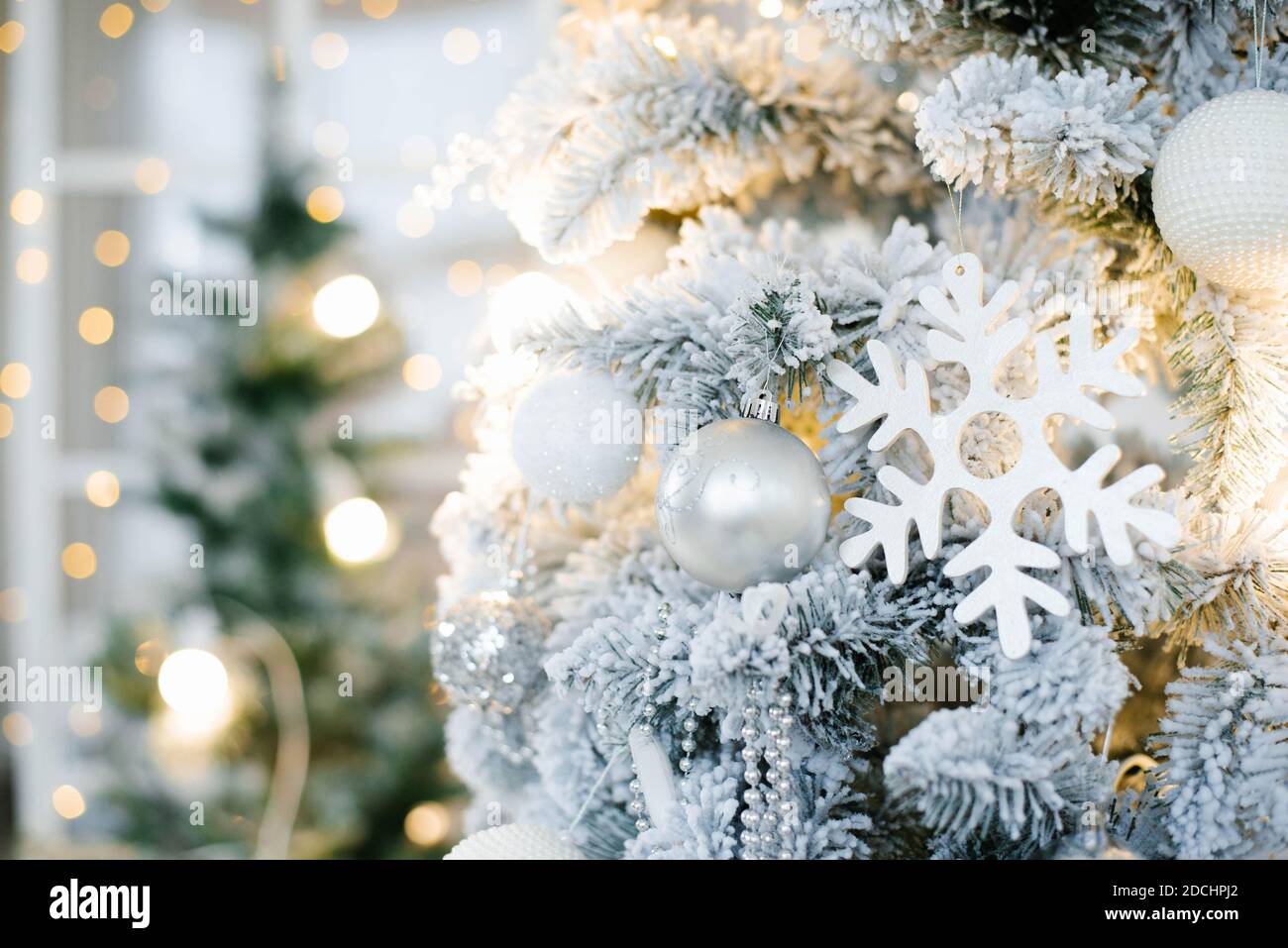 Elegante schöne silberne Weihnachtsbaum mit weißen und goldenen Ballons aus der Nähe. Hintergrund für den Kopierbereich Stockfoto