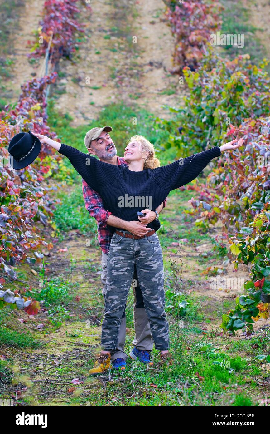 Reifes junges Paar Bauern in einem Weinberg Ackerland scherzen. Stockfoto