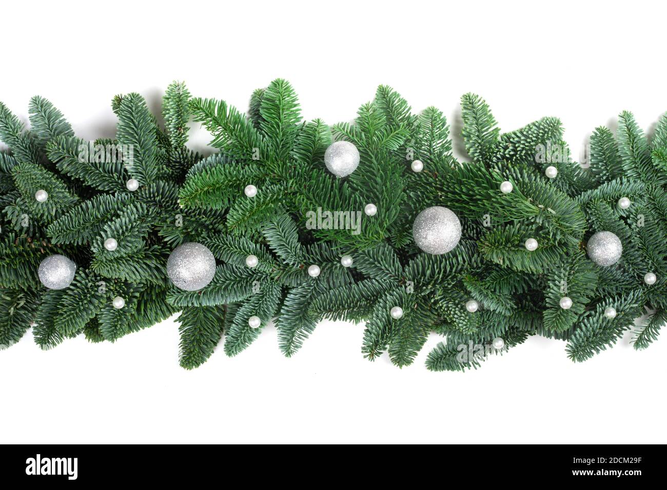 Weihnachten Rahmen von natürlichen edlen Tannenzweigen und Silberne Kugeln isoliert auf weißem Hintergrund Stockfoto