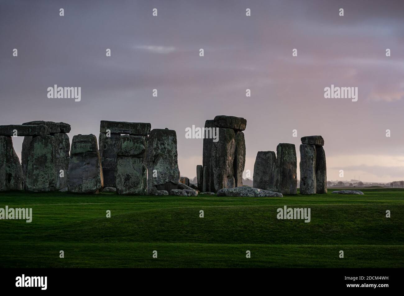 Subtiles Abendlicht wird nach einer Regendusche über die stehenden Steine in Stonehenge geworfen. Wiltshire, England. Stockfoto