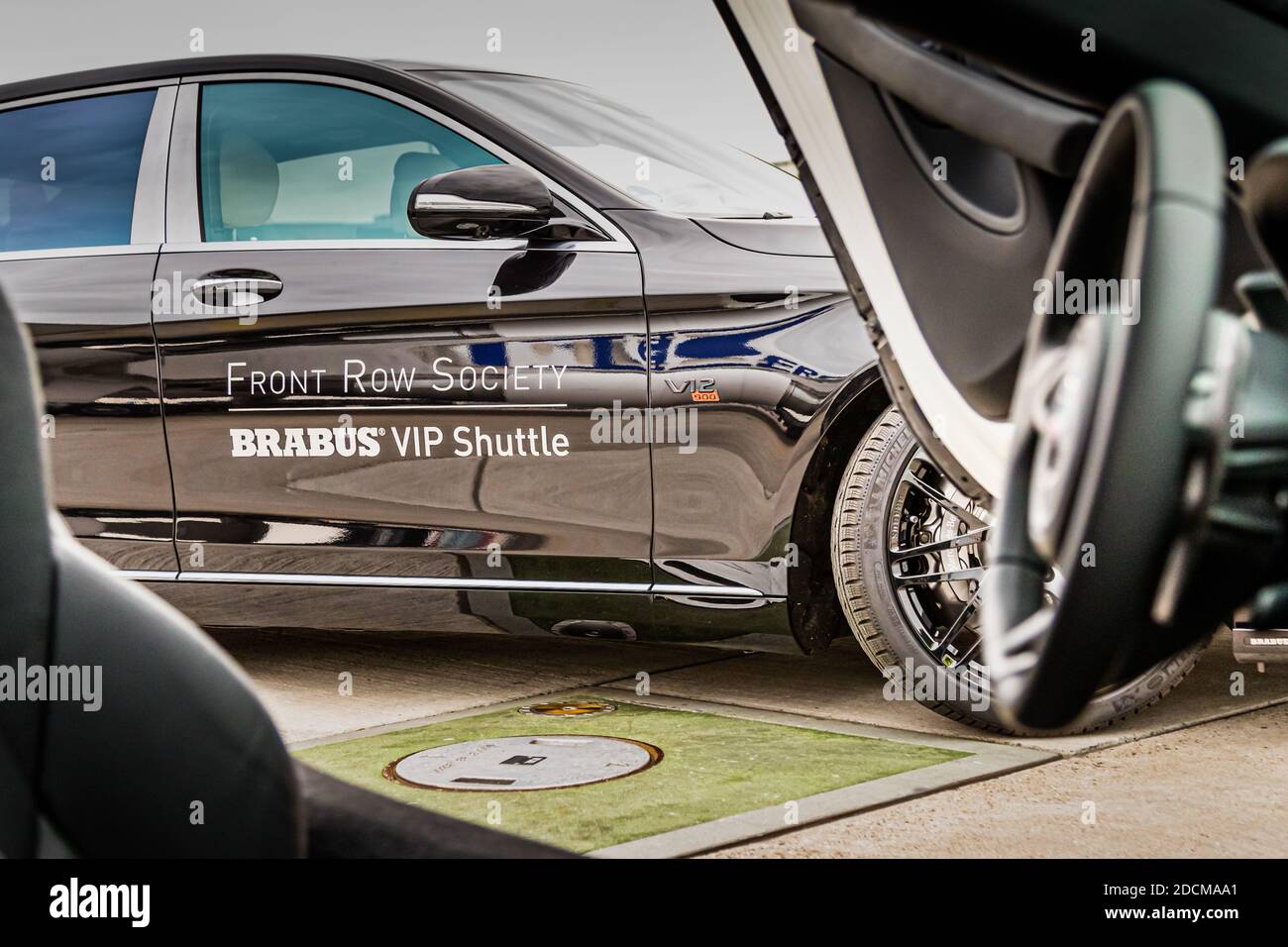 Detailfoto durch das Fahrzeugfenster des Brabus VIP Shuttle-Rads und der Fahrzeugseite. Professionelle Automobil-Detaillfotografie, die Branding und Radgestaltung einfängt. Flughafengelände. Stockfoto