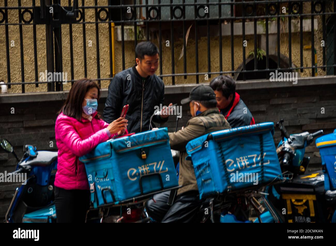 Fahrer, die Lebensmittel liefern, sprechen auf der Yuyuan East Road in Shanghai. Stockfoto