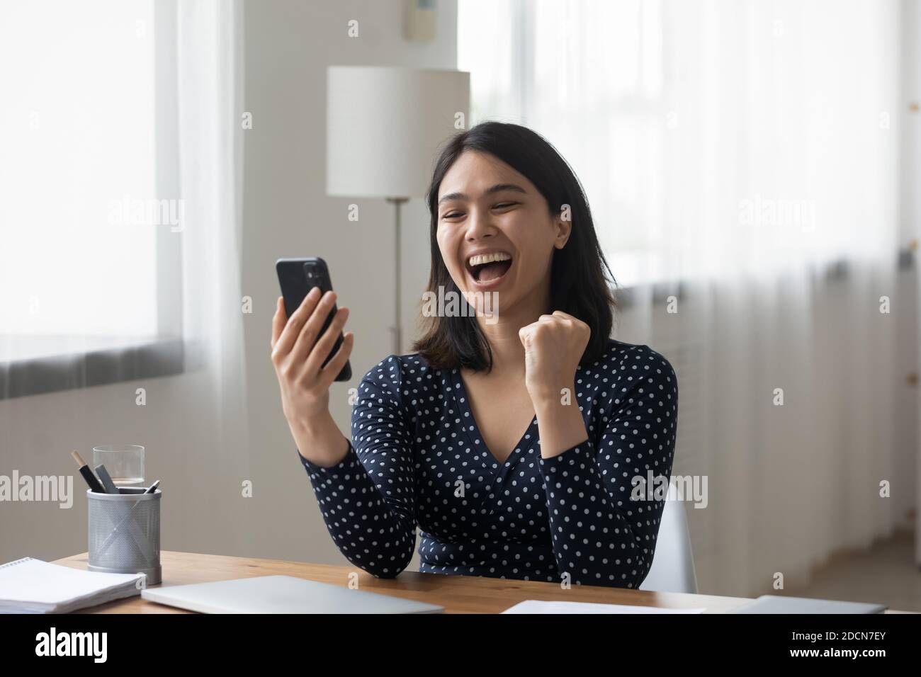 Überglücklich asiatische Frau lesen gute Nachrichten, Telefon halten, Erfolg feiern Stockfoto