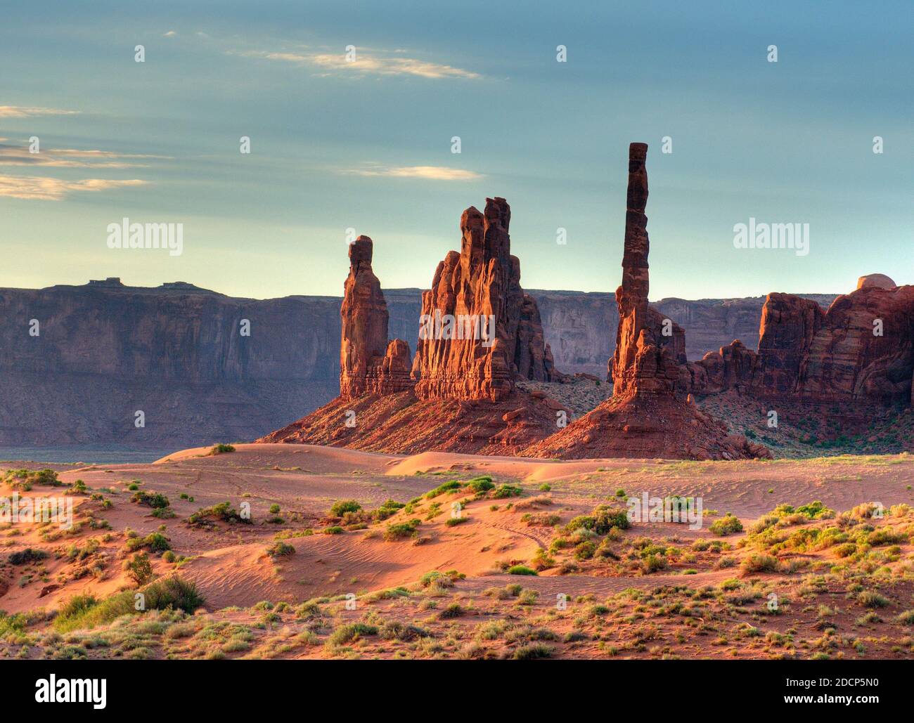 Blick Auf Den Totem Pole In Den Sanddünen Von Das Monument Valley Arizona am Morgen auf EINEM sonnigen Sommertag mit EINEM klaren blauen Himmel und EIN paar Wolken Stockfoto