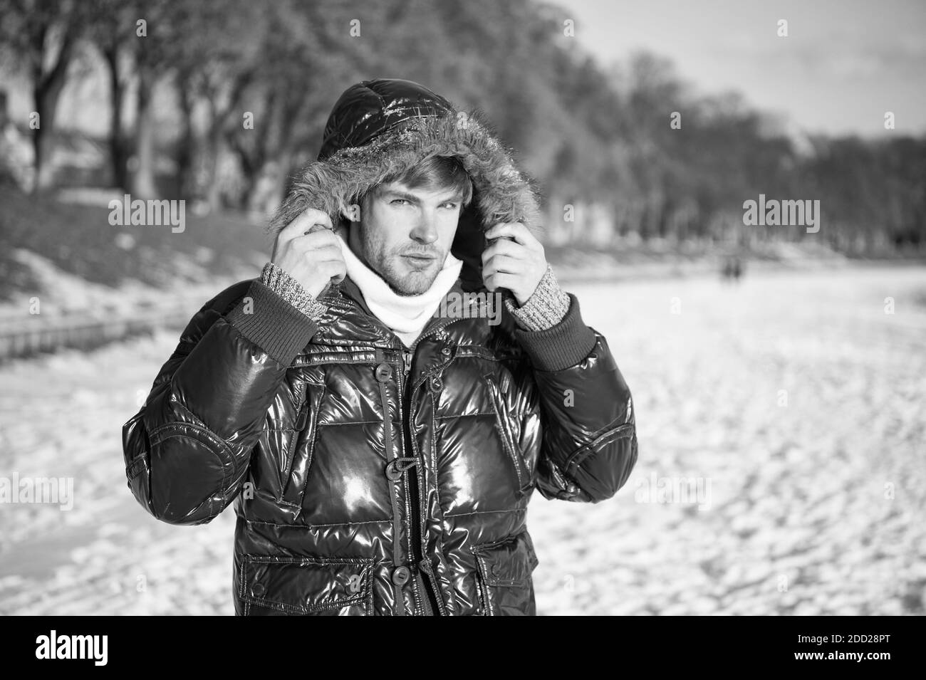 Natur ist schön. Platz für Gedanken. Kälte und Einsamkeit. Männlich in Daunenmantel mit Pelzhaube. Fühlen Sie sich warm und komfortabel. Lieblings-Saison. Umwelt-Konzept. Mann genießen Winterlandschaft. Stockfoto