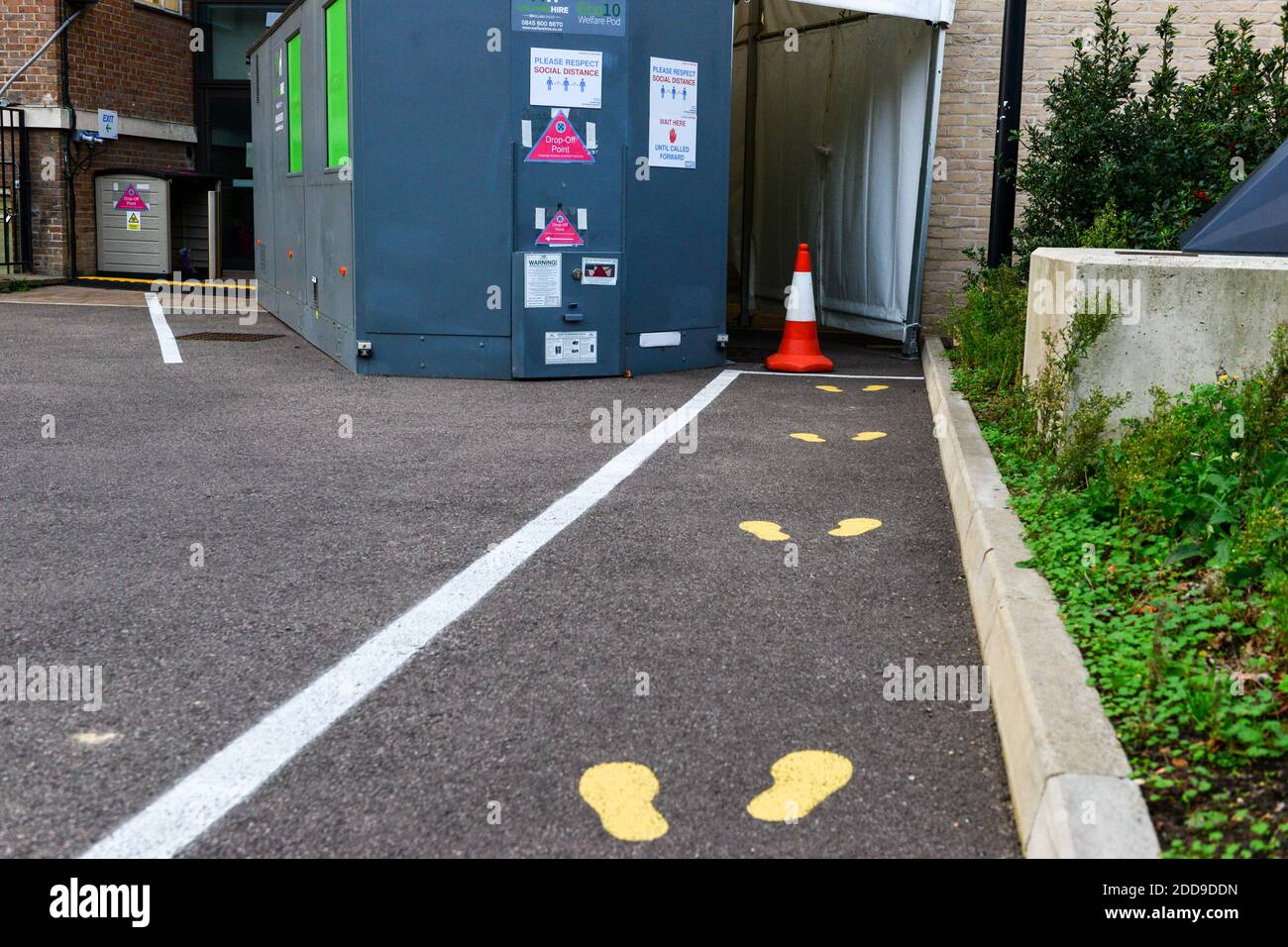 Cambridge UK, England ,24-11-2020, Bemalte Fußabdrücke auf Aschphalt außerhalb der Uniersity covid Teststation. Die Universität bietet Abstrichtests für Hochschulpersonal und Studenten an, die Symptome von COVID-19 aufweisen Stockfoto