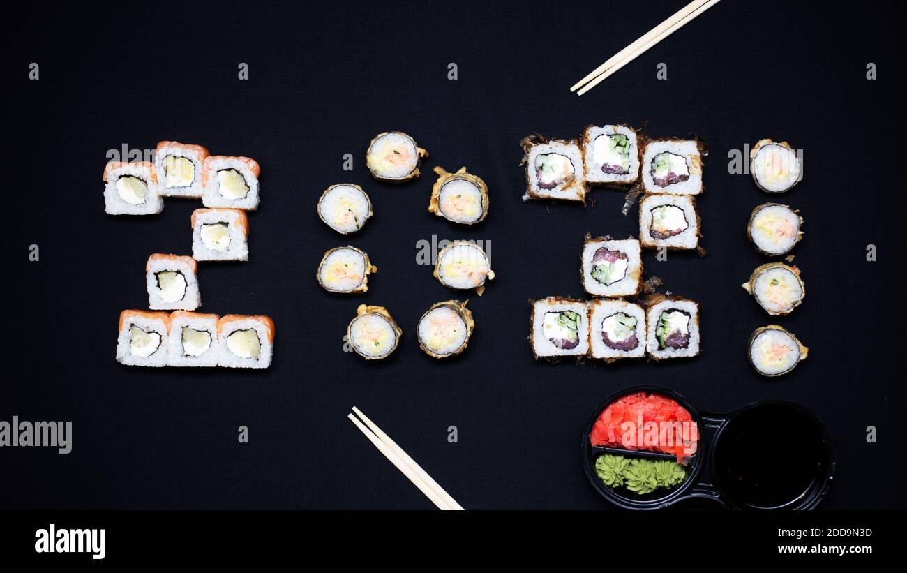 Komposition mit leckeren Sushi auf dunklem Hintergrund 2021 Jahr Stockfoto