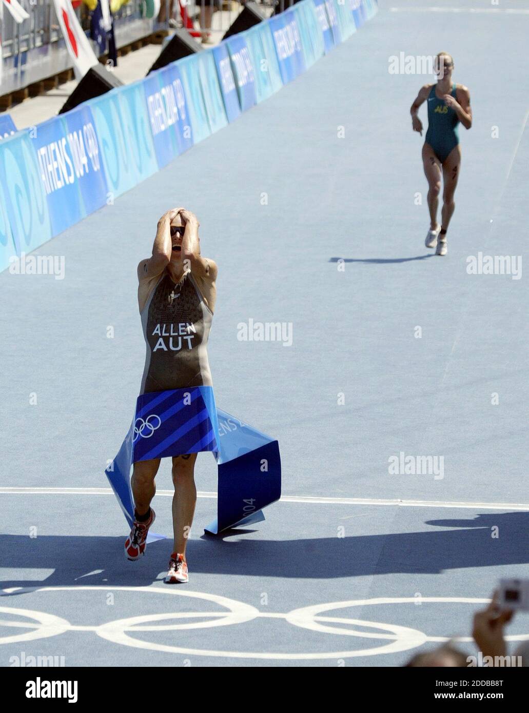 KEIN FILM, KEIN VIDEO, KEIN Fernsehen, KEIN DOKUMENTARFILM - die Österreicherin Kate Allen reagiert auf die Ziellinie, nachdem sie am Mittwoch, 25. August 2004, die Goldmedaille beim Frauen-Triathlon im Olympiazentrum Vouliagmeni in Athen gewonnen hat. Australiens Loretta Harrop, Spitze, nahm die Bronze. Foto von Julian Gonzalez/Detroit Free Stockfoto