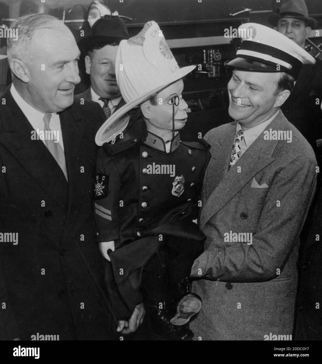 Der Bauchredner Edgar Bergen (1903-1978) (rechts) hält seine berühmteste Handpuppe, Charlie McCarthy. Charlie ist in seiner besten Chicago Feuerwehruniform gekleidet, so dass sie an einem Werbestunt oder Spendenaktion zur Unterstützung der Feuerwehr Chicago, wahrscheinlich in den 1950er Jahren, teilnehmen. Bergens andere berühmte Puppe war Mortimer Snerd. Bergen war ein amerikanischer Schauspieler, Komiker und Radiokünstler. Er begann seine Karriere in Vaudeville, nachdem er bereits Charlie geschaffen hatte, der sein Leben lang sein rosiger Freund sein sollte. Um meine anderen Geschäftsbilder zu sehen, Suche: Prestor vintage Acting Stockfoto