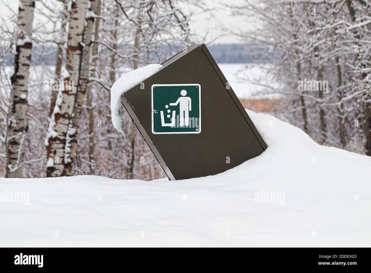 Ein Müllcontainer mit Hinweisschild im Winter Stockfoto
