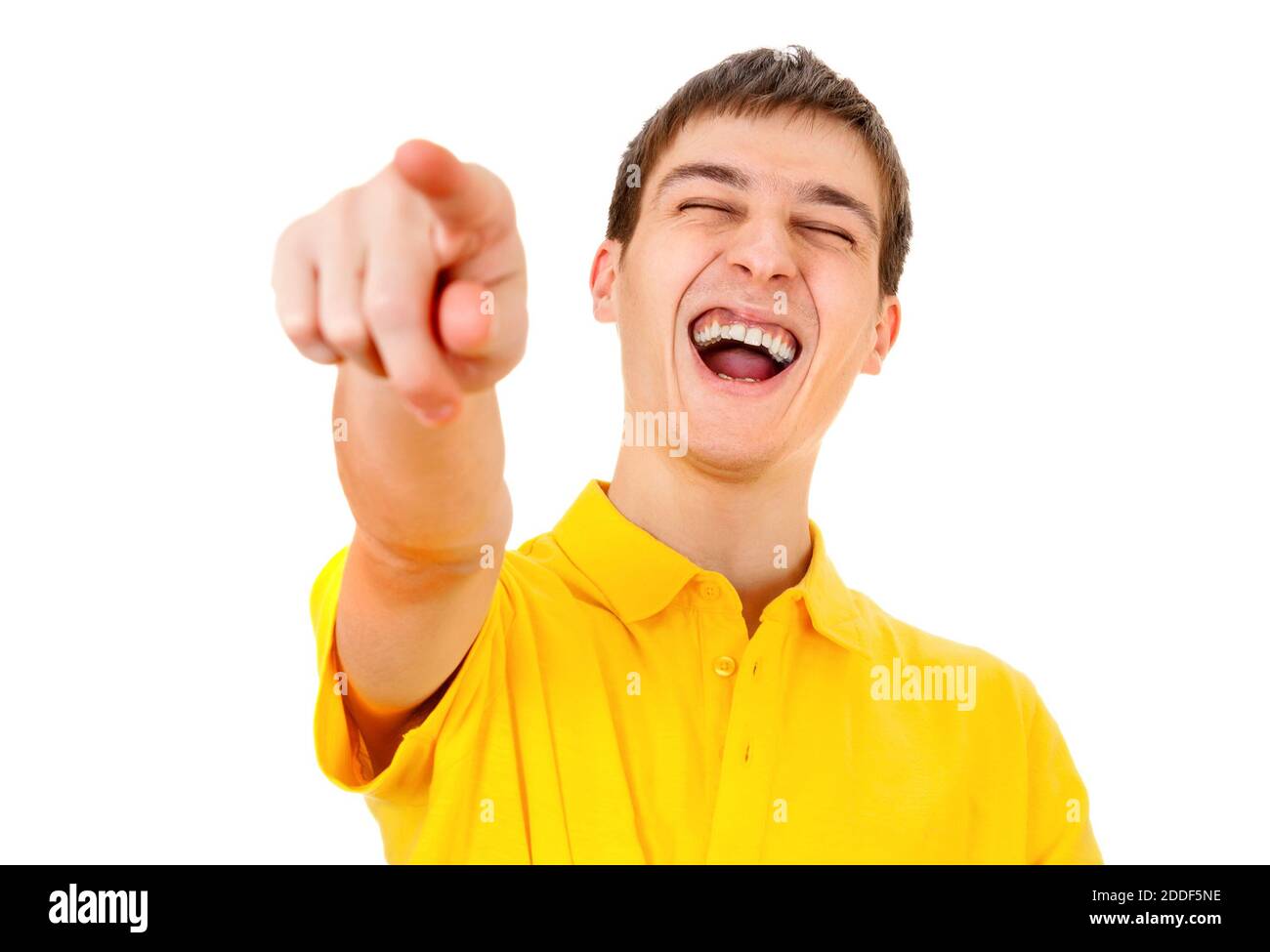 Fröhlicher junger Mann, der auf den weißen Hintergrund zeigt und lacht Nahaufnahme Stockfoto