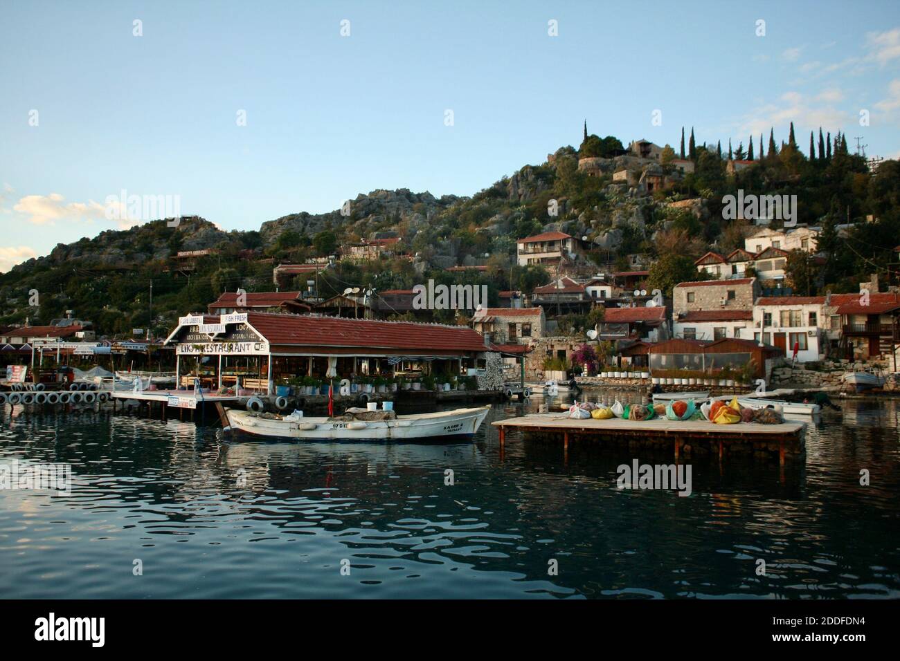 Boote, touristische Fischrestaurants und alte Steinhäuser am Ufer des Flusses und See von atatürk Damm. Stockfoto