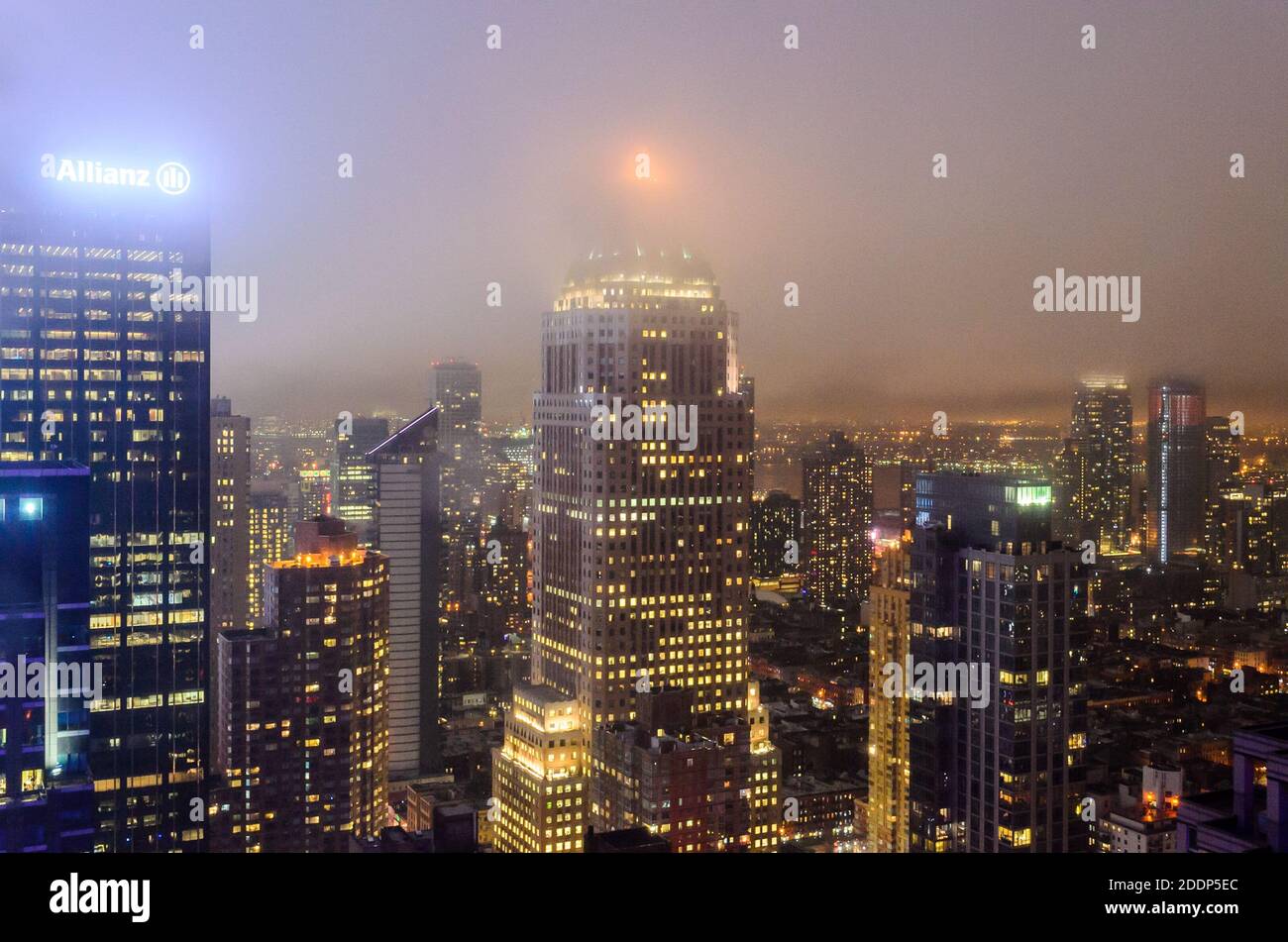 Luftaufnahme von Gebäuden, Wolkenkratzern und Türmen in Manhattan in einer foggy Nacht des Winters. Helle Lichter an den Türmen. New York City, USA Stockfoto