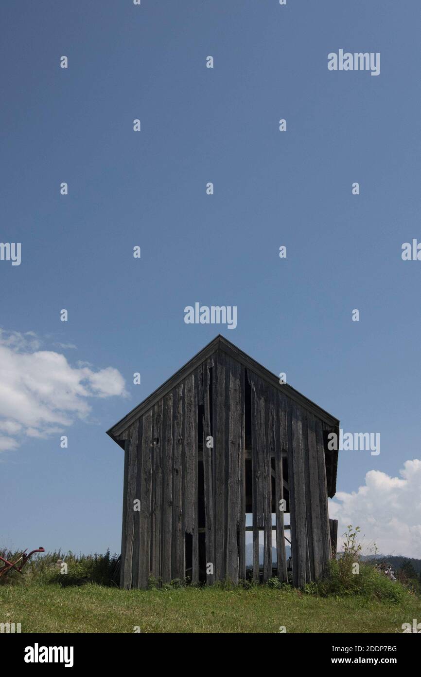 Holzhütte in den alpen, blauer Himmel und Wolken im Hintergrund Stockfoto