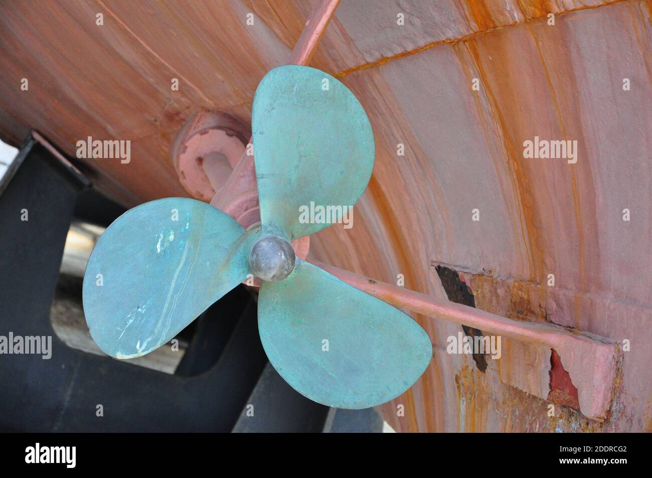 Propeller an Bord in einer trockenen Marina.Propeller im Umbau. Unter dem Schiff. Großes Schiff wird auf Trockendock repariert Stockfoto