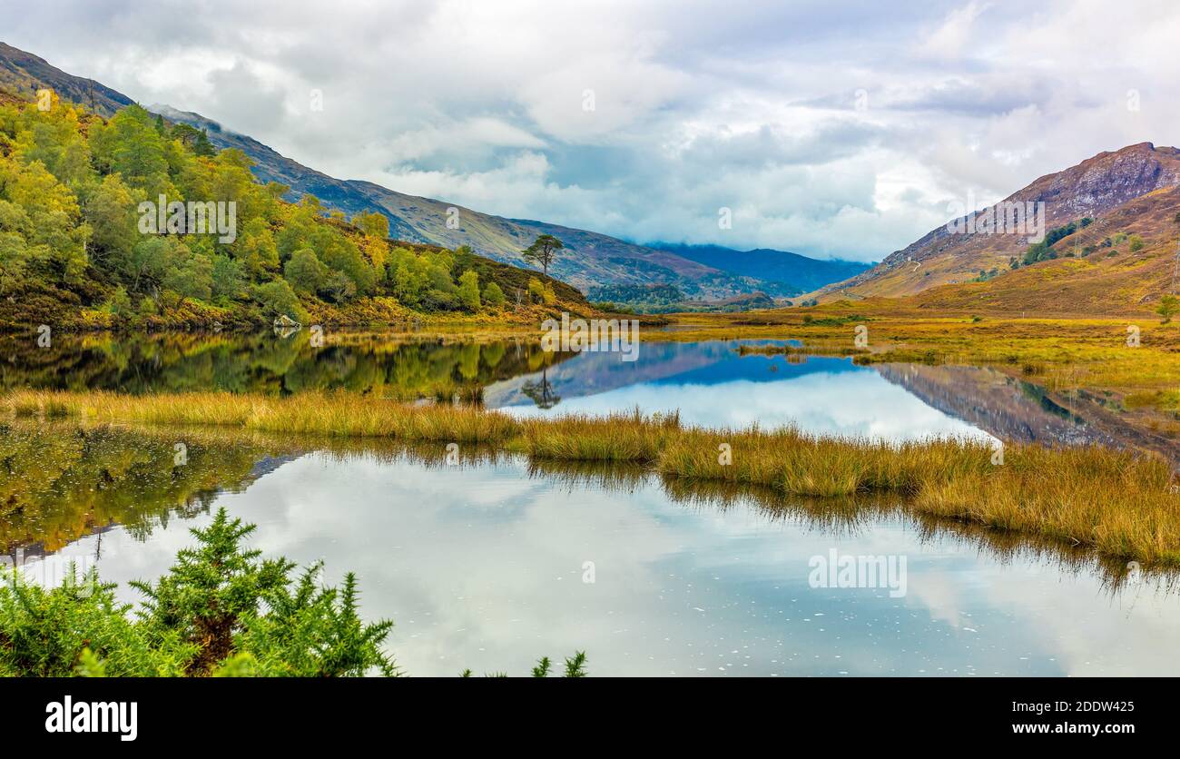 Glen Strathfarrar im Herbst mit farbenfroher Herbstlandschaft und Reflexionen im loch. Highlands of Scotland. Querformat, Platz für Kopie. Stockfoto