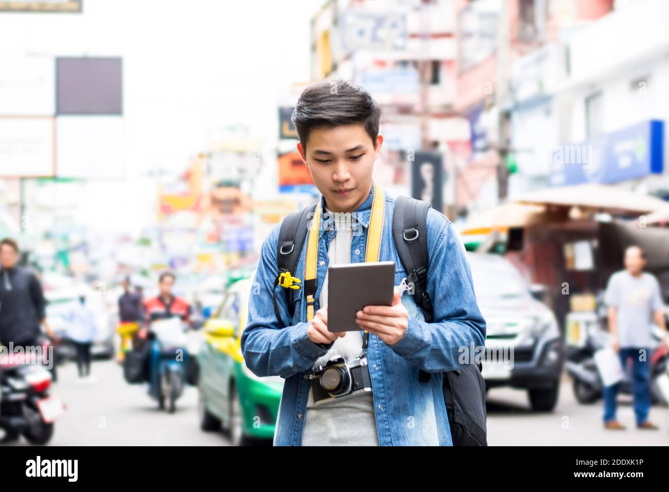 Asiatische Fotograf Tourist Backpacker mit Tablet, um Position zu finden, während Reisen im Urlaub in Khao San Road Bangkok Stadt Stockfoto