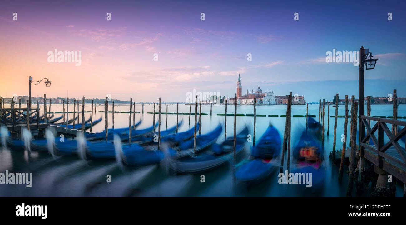 Lagune von Venedig bei Sonnenaufgang, Kirche San Giorgio Maggiore und Gondeln. Italien, Europa. Langzeitfotografie. Stockfoto