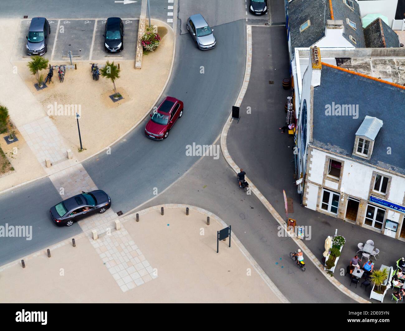 Luftaufnahme einer Kreuzung mit Radfahrern und Autos Neben einem Straßencafé in Penmarc'h Finisterre Bretagne Frankreich Stockfoto
