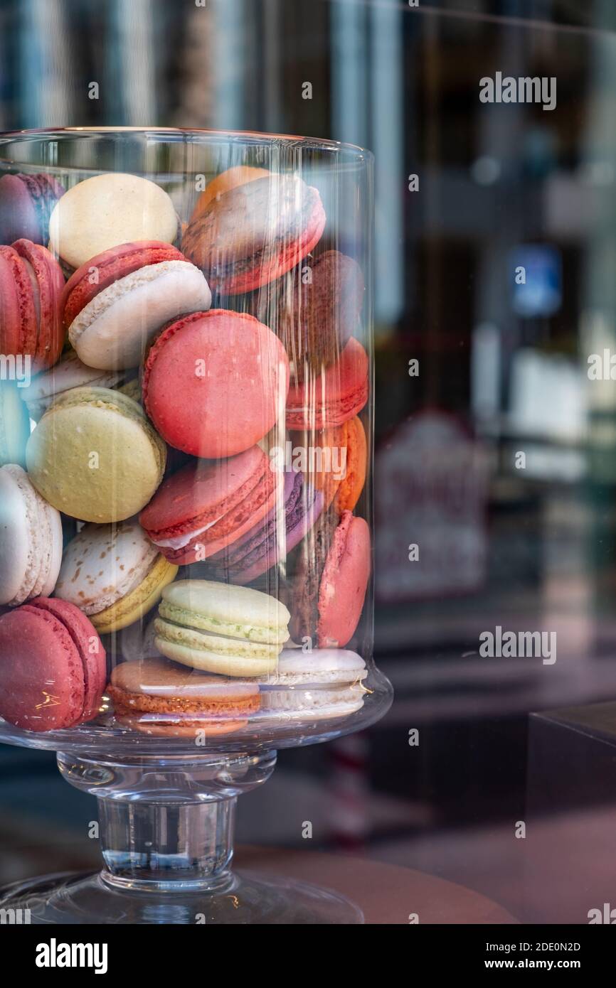 Makronen in einem Glas. Französische bunte zarte Süßigkeiten Sortiment, vertikal. Schaufenster des Süßwarenladens Stockfoto