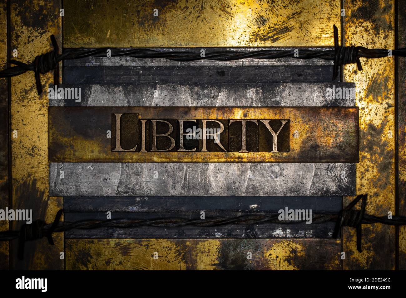 Liberty Text mit Stacheldraht auf texturiertem Graukupfer und Vintage Gold Hintergrund Stockfoto