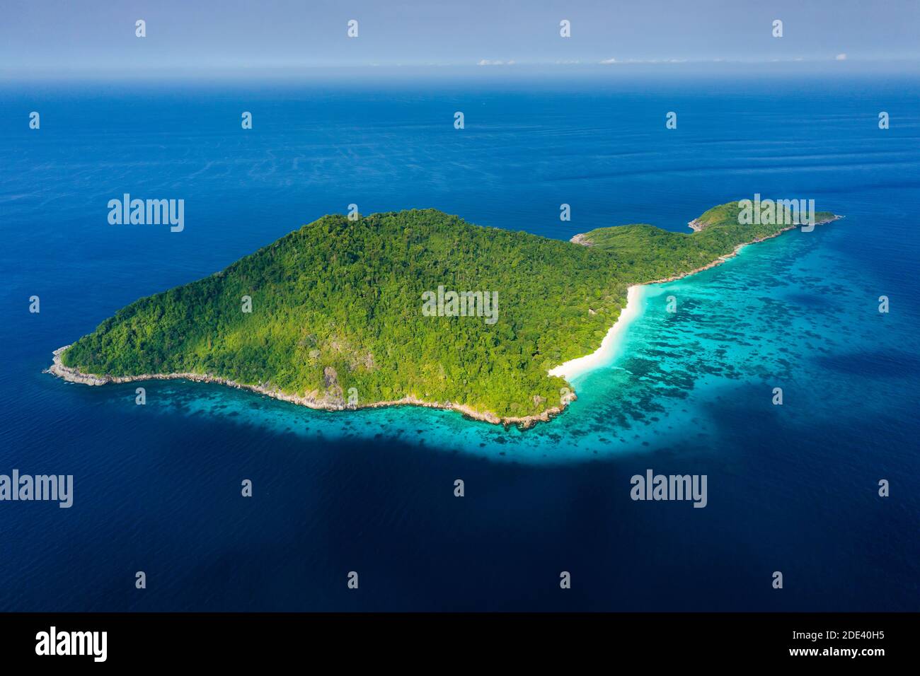 Luftaufnahme eines einsamen Strandes auf einer zerklüfteten tropischen Insel, umgeben von Korallenriff (Koh Tachai). Stockfoto