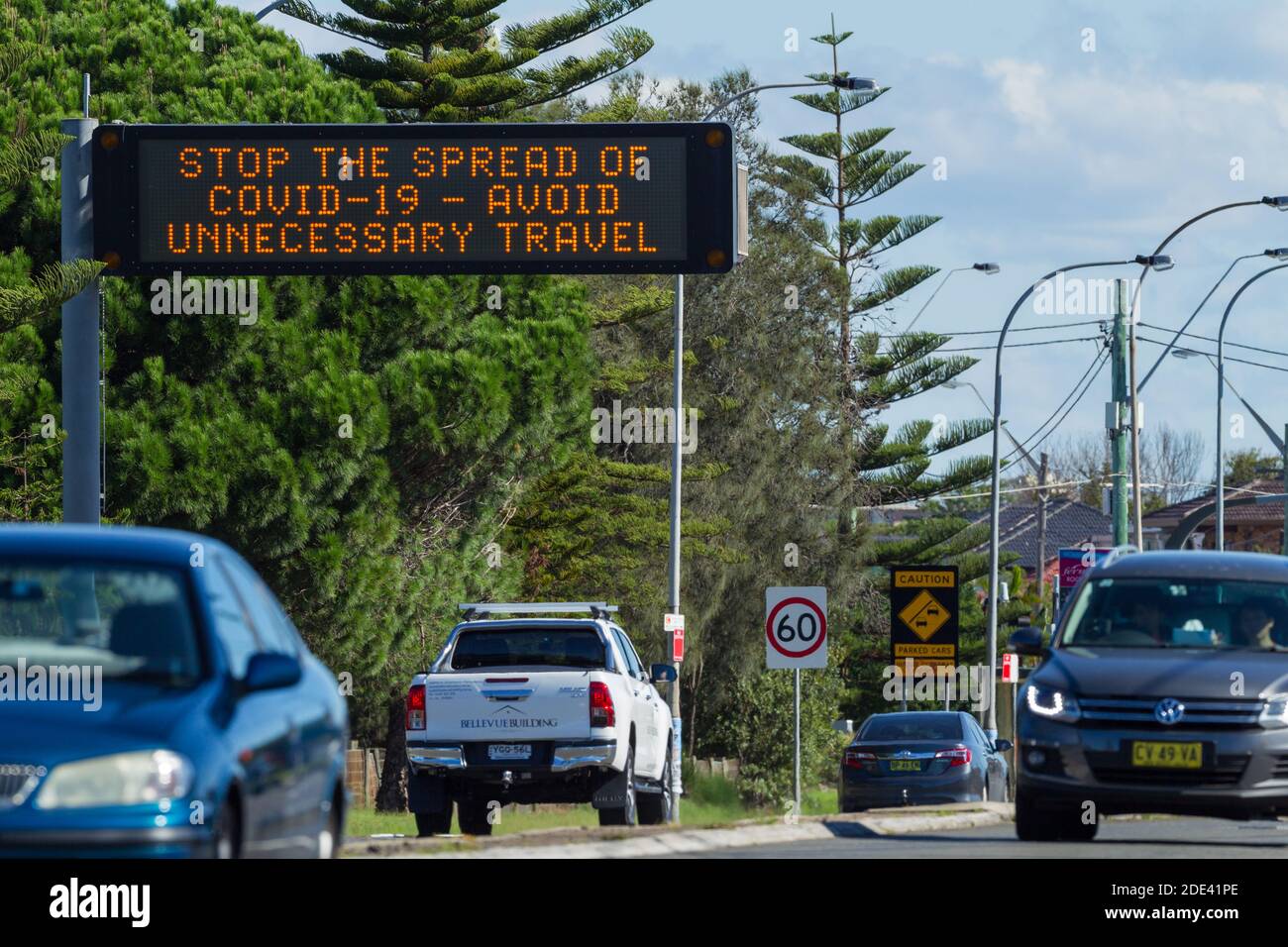 Verkehr auf dem General Holmes Drive in Kyeemagh an der Botany Bay in der Nähe des Flughafens Sydney in Sydney, Australien, mit einem öffentlichen Hinweisschild, das vor den Risiken unnötiger Reisen während der COVID-19 Coronavirus-Pandemie warnt. Stockfoto