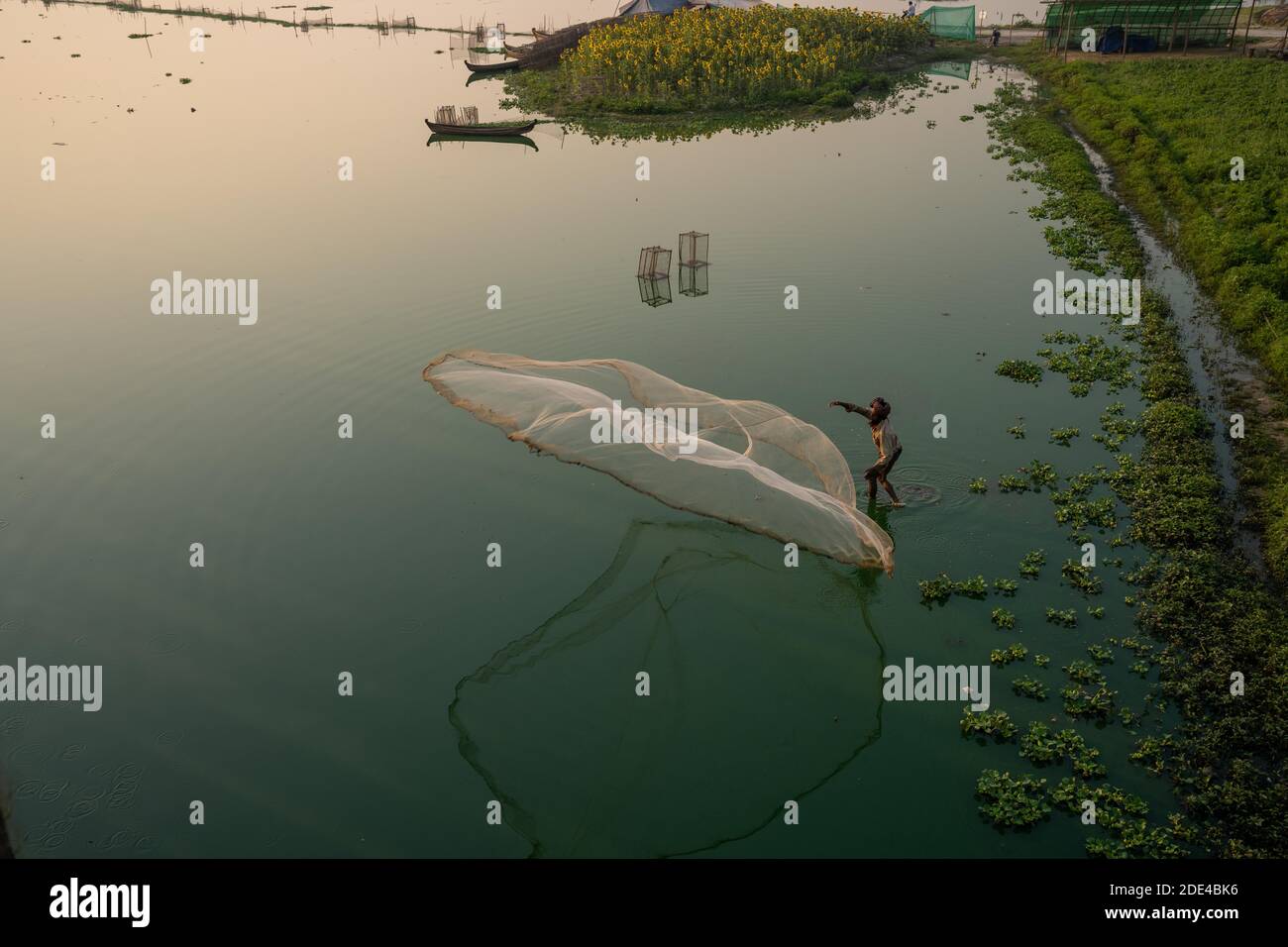 Fischer auf Taung Tha man See werfen ein Fangnetz für Sonnenaufgang, Reflexion im Wasser, Thaung Tha man See, Mandalay, Myanmar Stockfoto